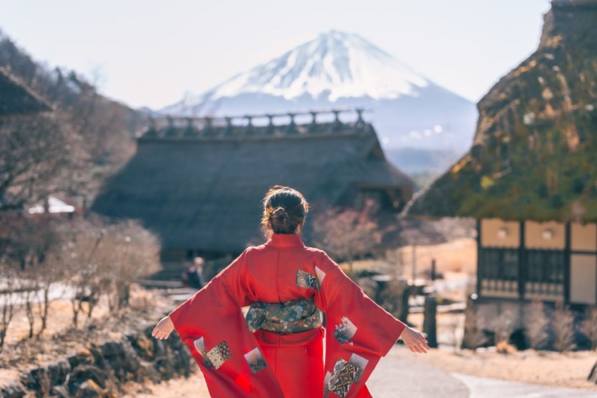 woman wearing kimono facing Mt Fuji